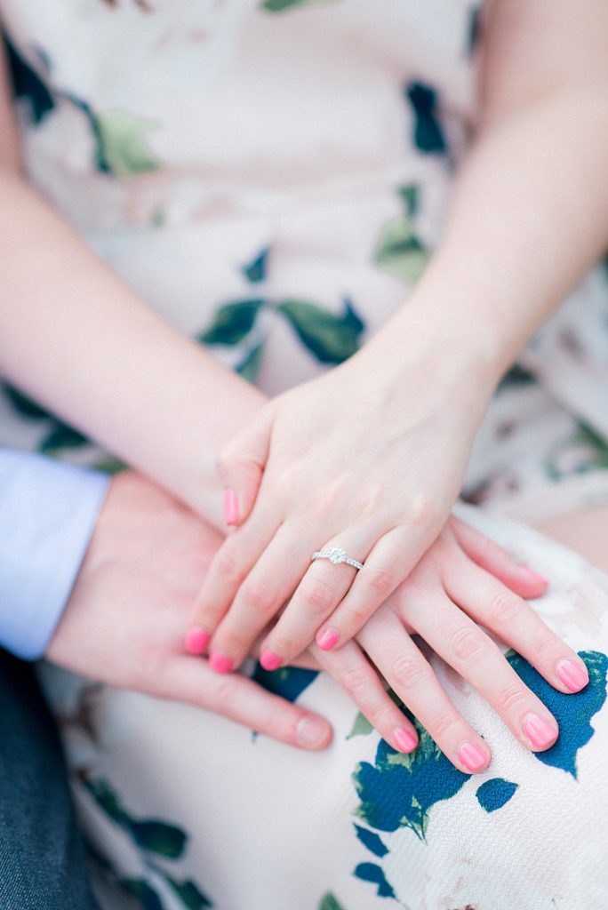 couple's hands with engagement ring