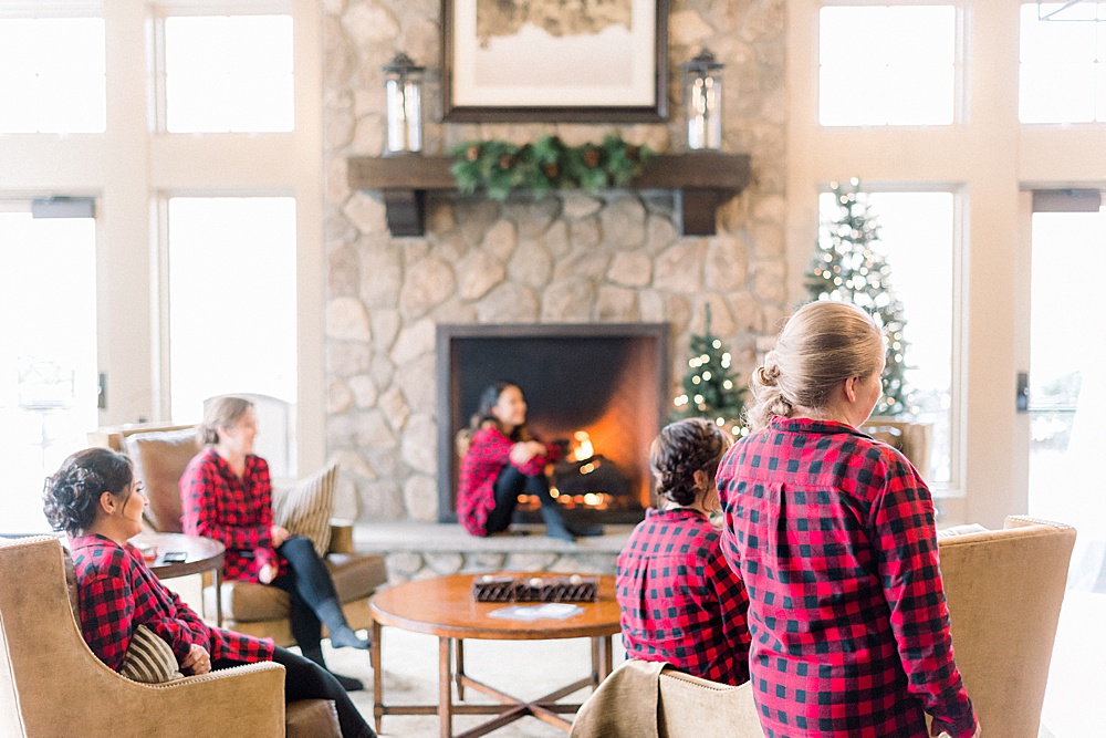 bridesmaids lounging in front of fireplace