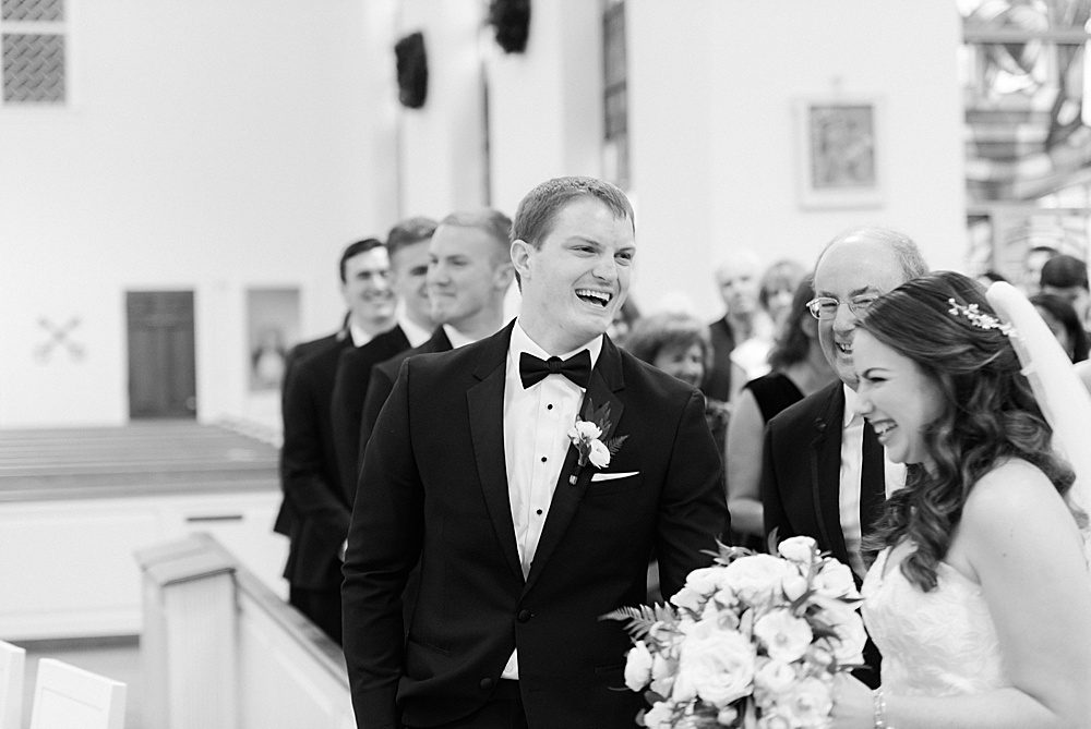 groom reacts to bride walking down aisle