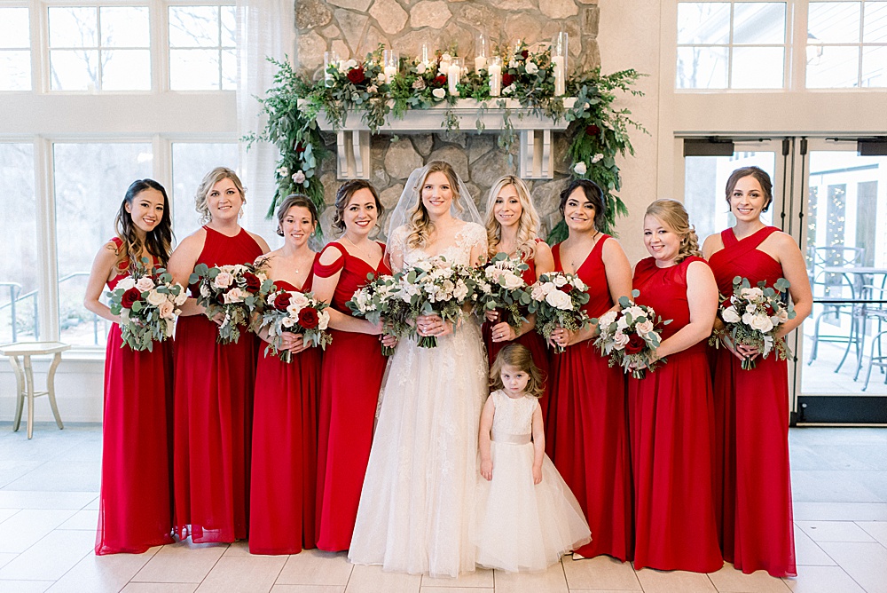 bridesmaids in front of stone wall