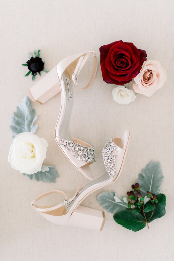 bridal shoes flat lay with blooms