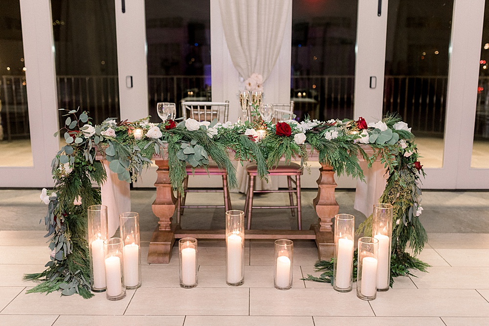 sweetheart table decorated with holiday florals