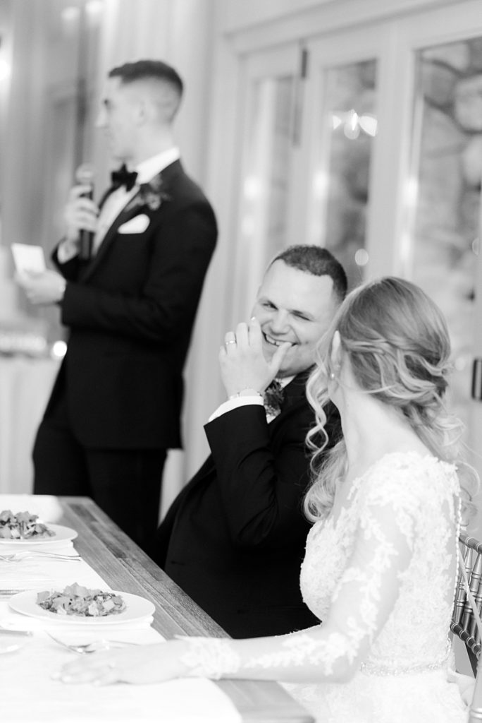 bride and groom laugh together during speeches